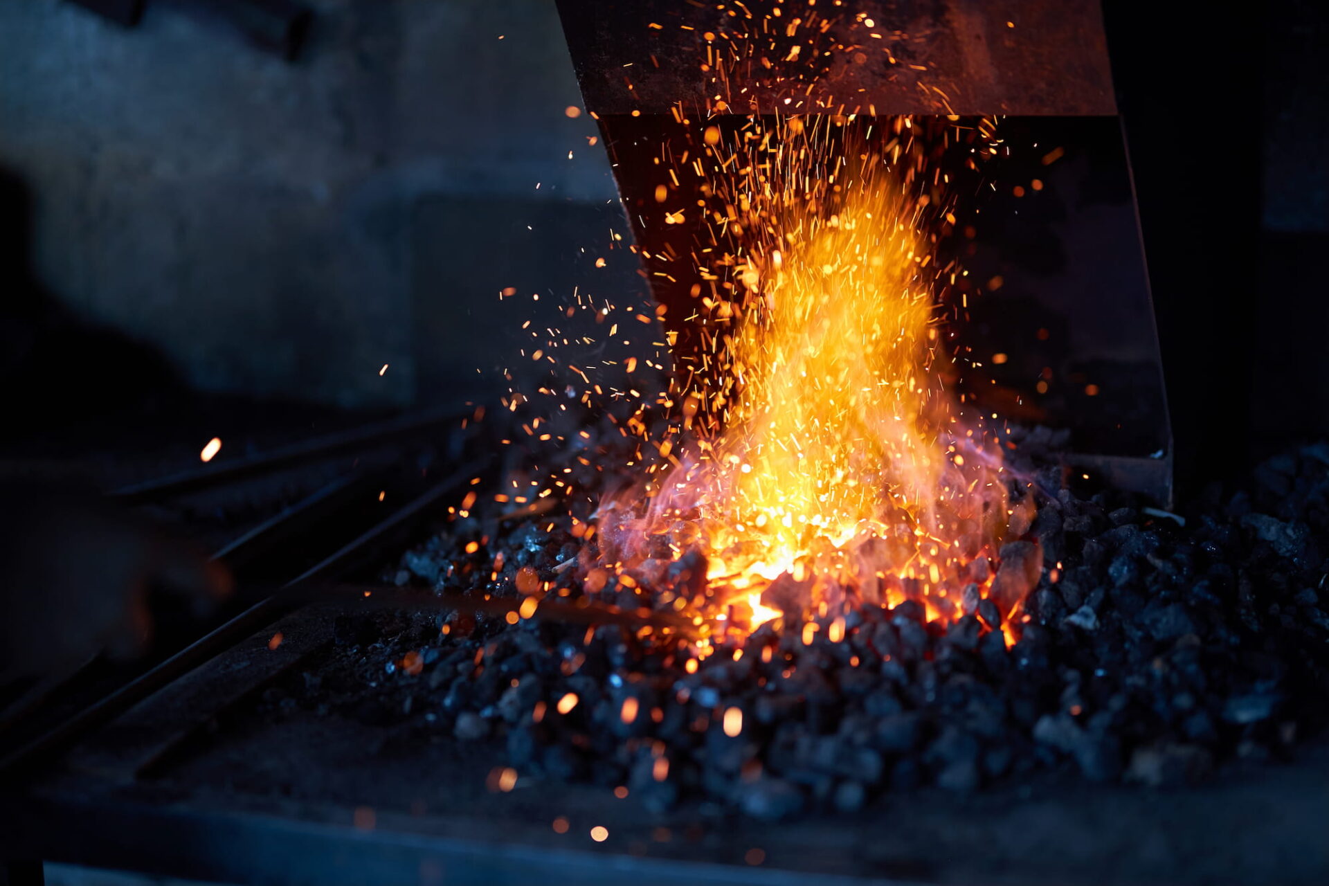 Red hot metal in burning fire preparing for forging process