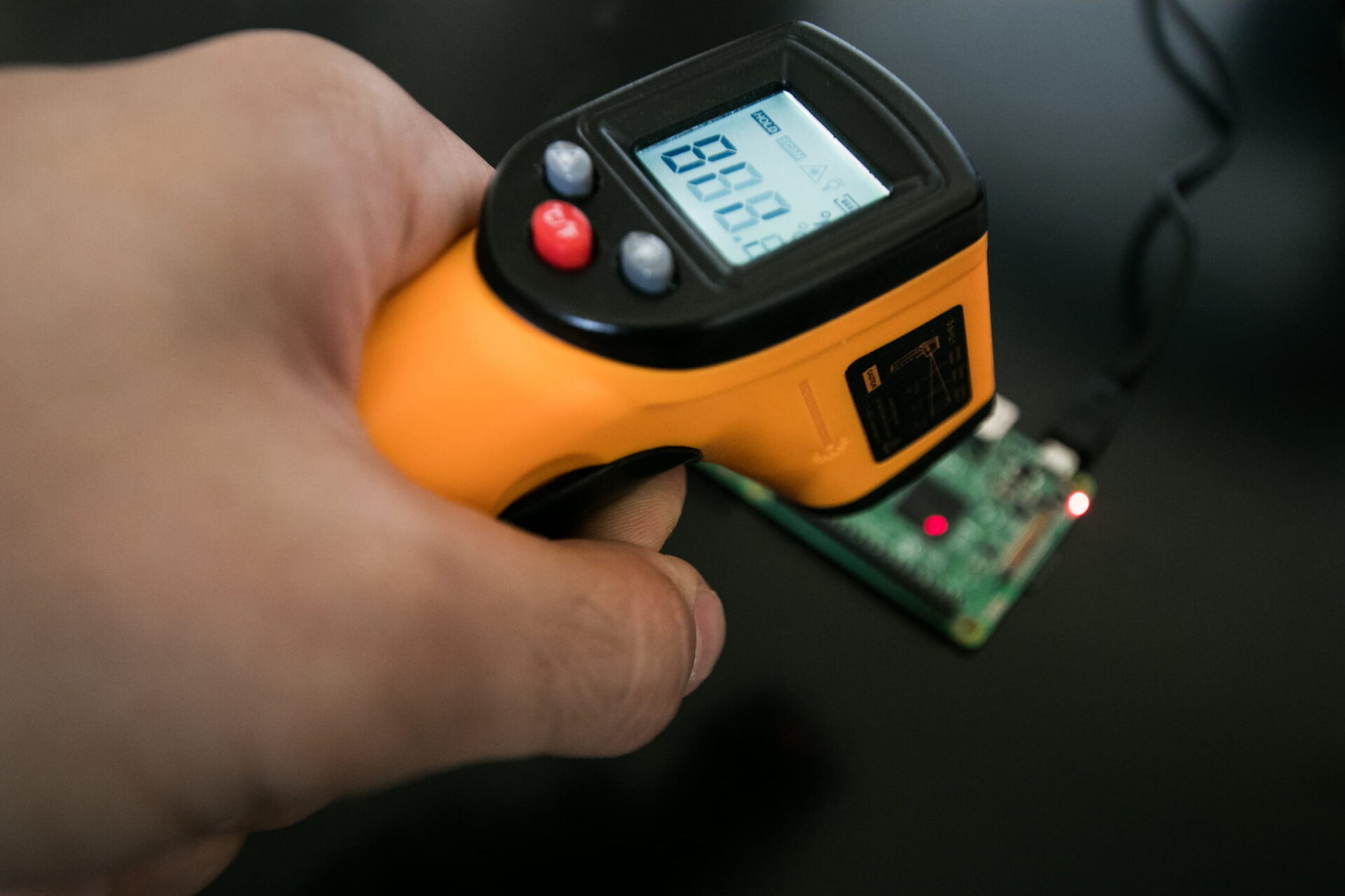 Infrared thermometer, with laser point, measures the chipset temperature of a single board.